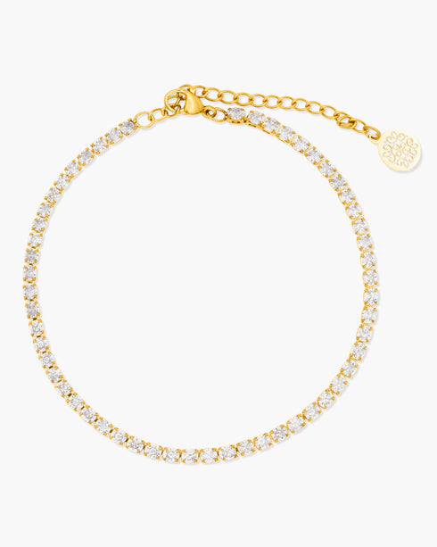 Gold anklet with clear stones on a white background